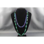 A malachite graduated barrel-shaped bead necklace,