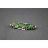 An Art Deco white gold and jadeite brooch,