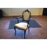 An Edwardian carved mahogany framed cameo back open arm occasional chair,