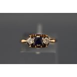 A 9ct gold, synthetic sapphire and colourless paste three stone ring, Birmingham 1986, size O,