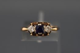 A 9ct gold, synthetic sapphire and colourless paste three stone ring, Birmingham 1986, size O,