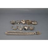 A silver curb link bracelet and nine various gem set rings including marcasite,