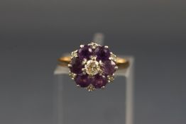 A gold, amethyst and diamond cluster ring, centred with a round brilliant diamond approx. 0.