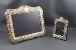 A modern silver mounted photograph frame embossed with foliate scrolls, anthemion and a cartouche,