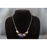 A Continental white metal and lapis lazuli necklace,