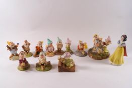 A collection of twelve Royal Doulton Snow White and the Seven Dwarves figures comprising: Snow