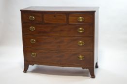 A 19th century bow fronted chest of three short and three long drawers with brass handles and