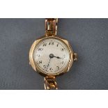 A 9ct gold cased bracelet watch, circa 1922, silvered dial with black Arabic numerals,