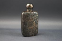 A silver miniature scent bottle engraved with foliate scrolls and a cartouche engraved with a