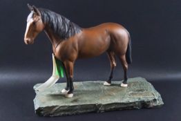 A Beswick horse 'Cleveland Bay' on a painted slate base
