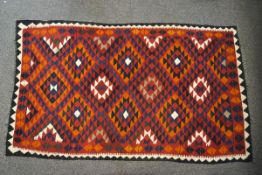 A Turkish multi-coloured kelim with repeating diamond pattern to the field,