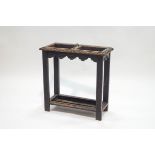 A Victorian carved oak stick stand, the central divider with brass handle,