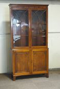 An early 19th century mahogany bookcase with two astragal glazed doors above two panelled doors,