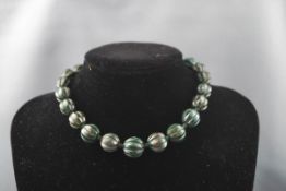 A bloodstone fluted-bead necklace on a bolt ring clasp, approx.