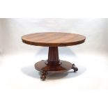 A William IV rosewood breakfast table upon turned and carved inverted column,