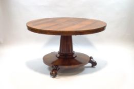 A William IV rosewood breakfast table upon turned and carved inverted column,