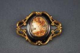 A Victorian black enamel and gold-plated shaped-oval mourning brooch,