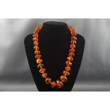 An amber necklace, the irregular shaped beads graduated approx.