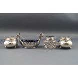 A pair of small silver cauldron shaped salt cellars, each on three ball feet,