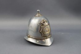 A silver plated table bell in the form of a Metropolitan policeman’s helmet,