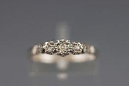 An early 20th century gold and diamond three stone ring by Bravingtons,