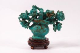 A Chinese turquoise coloured hardstone carving of flowers in a vase, 8cm high,