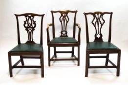 A pair of George III mahogany dining chairs, one a carver, with decorative pierced splats,