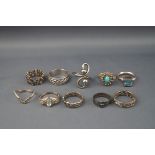 Ten silver and white metal rings, some gem set including a Victorian buckle ring, Birmingham 1882.