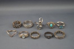 Ten silver and white metal rings, some gem set including a Victorian buckle ring, Birmingham 1882.