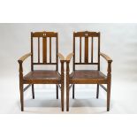 A pair of Arts and Crafts style oak armchairs with triple splat backs,