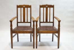A pair of Arts and Crafts style oak armchairs with triple splat backs,