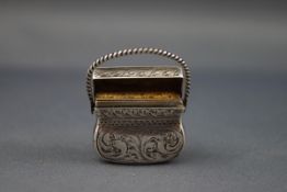 A Victorian silver vinaigrette in the form of a purse or bag,