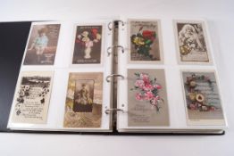 A quantity of Victorian and later postcards within three albums, including humorous, greetings,