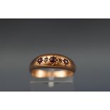 An Edwardian 9ct rose gold and small ruby and diamond gypsy ring, Birmingham 1905, size O+, 1.