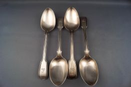 Four early Victorian silver fiddle and thread pattern table spoons with conforming crests,