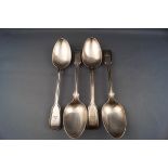 Four early Victorian silver fiddle and thread pattern table spoons with conforming crests,