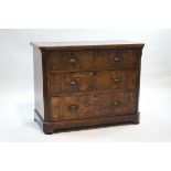 A Continental walnut chest of two short and two long drawers,