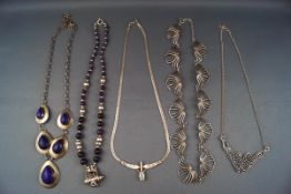 Five silver and white metal necklaces,
