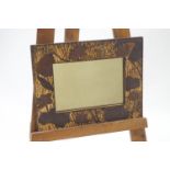 A Japanese style wall mirror with carved wood water lilies to the frame, 46.