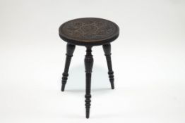 A Welsh carved and stained three legged stool,