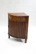 A 19th century mahogany bow fronted corner cabinet with sliding drawer above a tambour front,