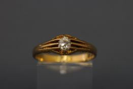 An early 20th century 18ct gold and diamond solitaire gypsy ring, the old-cut stone approx. 0.