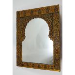 An Islamic style wall mirror, ornately painted with Middle Eastern motifs,