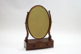 A 19th century oval swing frame mirror, the bowfront box base with two drawers,