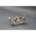 A silver novelty vesta/match case in the form of a foliate crescent 'man in the moon' with glass