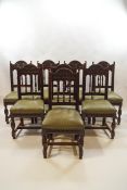 A set of eight late Victorian carved oak dining chairs,