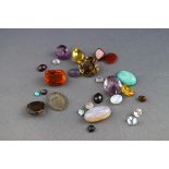 A selection of loose gemstones to include smokey Quartz, amethyst, Garnet, Opal, Amazonite,