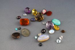 A selection of loose gemstones to include smokey Quartz, amethyst, Garnet, Opal, Amazonite,