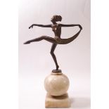 An Art Deco spelter figure of a dancing girl with arms outstretched,
