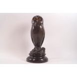 After Milo, a bronze figure of an owl with amber eyes,